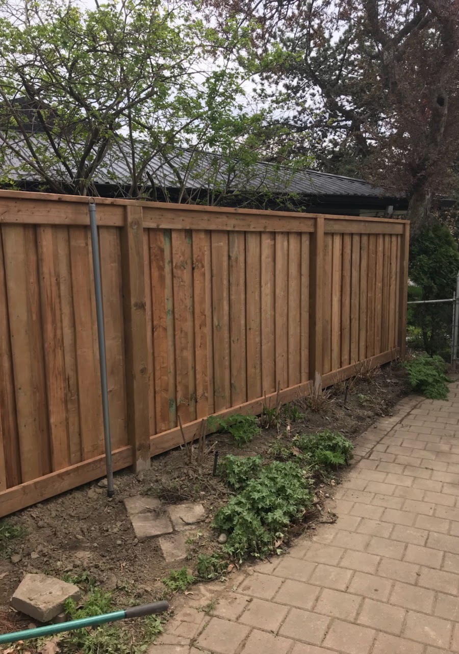 Vertical board fence with cap rail Toronto